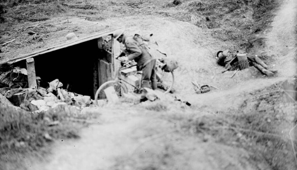 139_A Canadian cyclist shouting down a dug-out in German for men to come out. Advance East of Arras